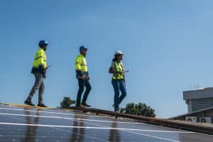 Service engineer checking solar cell on the roof for maintenance if there is a damaged part. Engineer worker install solar panel. Clean energy concept.